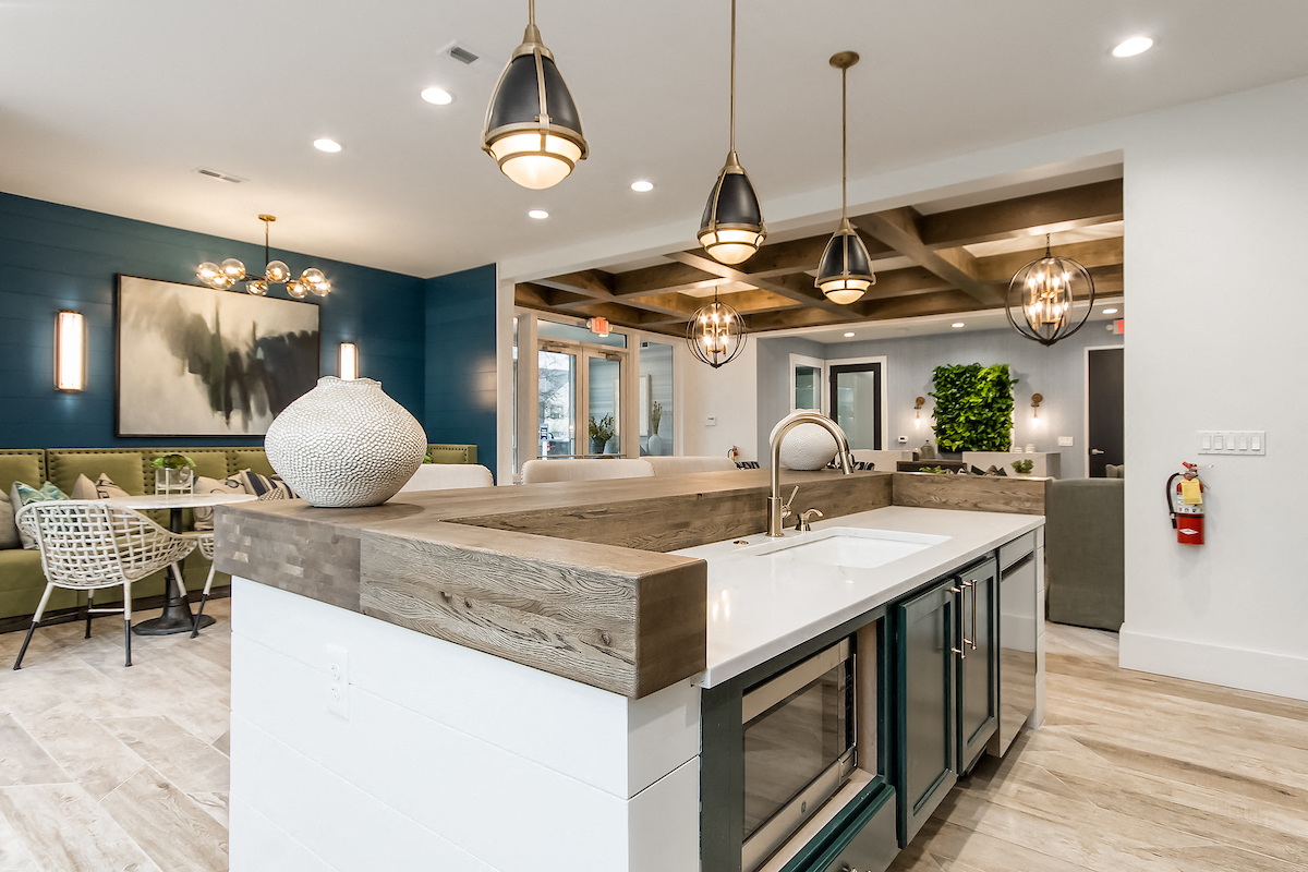 an open concept kitchen with a large island and a dining area