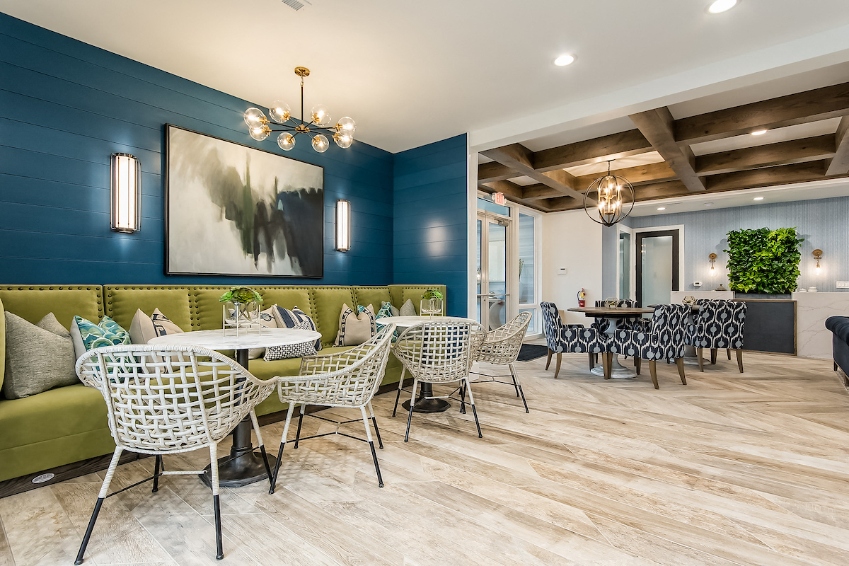 a restaurant with blue walls and white tables and chairs