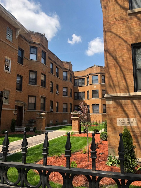 a fence in front of an apartment building