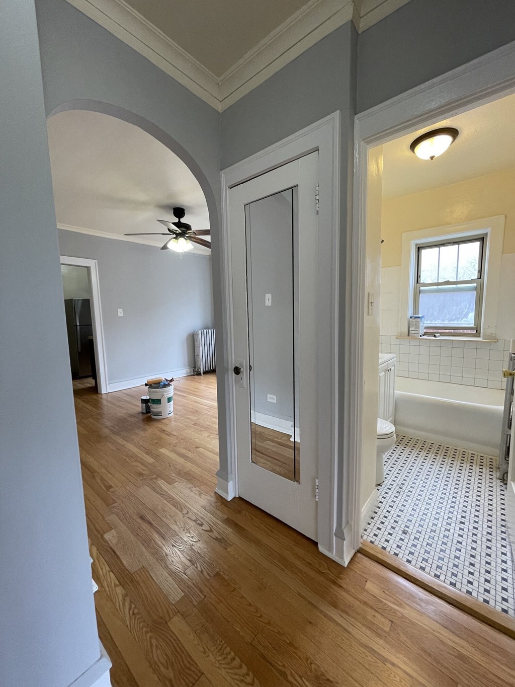 a view of the living room from the hallway with the door open to the bathroom