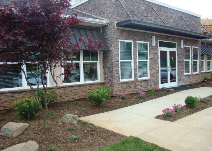a house with a sidewalk in front of it