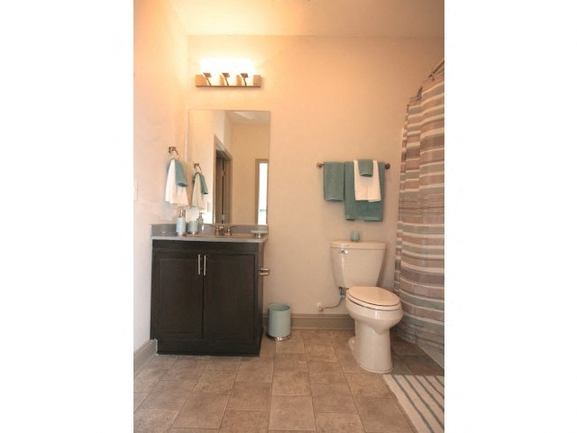 a bathroom with a toilet and a sink and a mirror