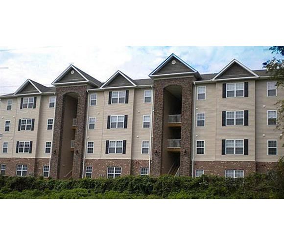 a large apartment building with three roofs on top of it