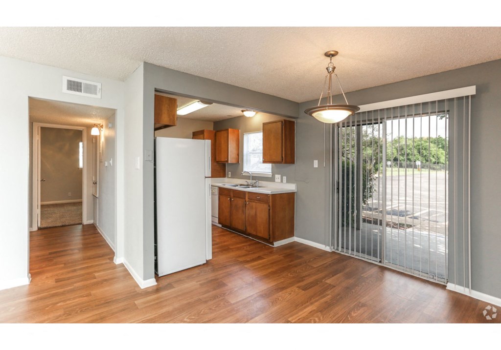an open kitchen with a sliding glass door to a patio