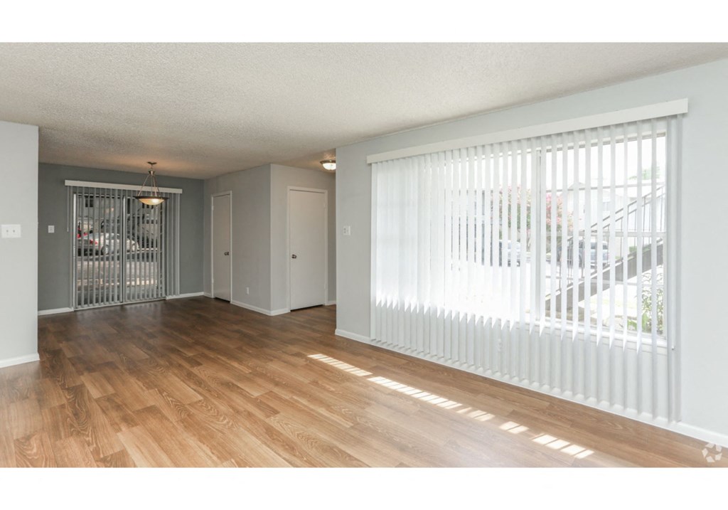 the living room is open to the dining room and the front door to the kitchen