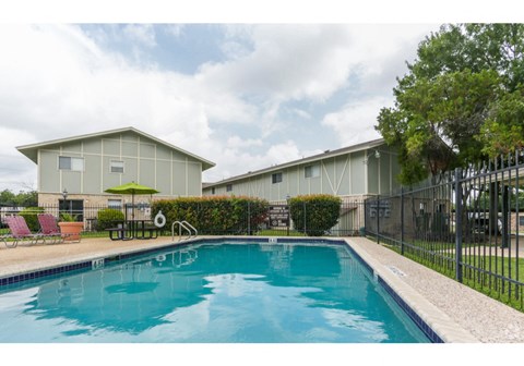 a pool with a house in the background