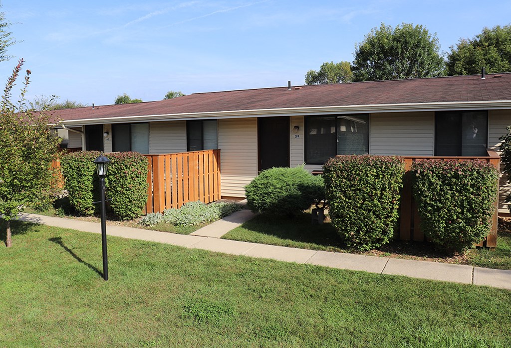 a small house with a yard and a sidewalk