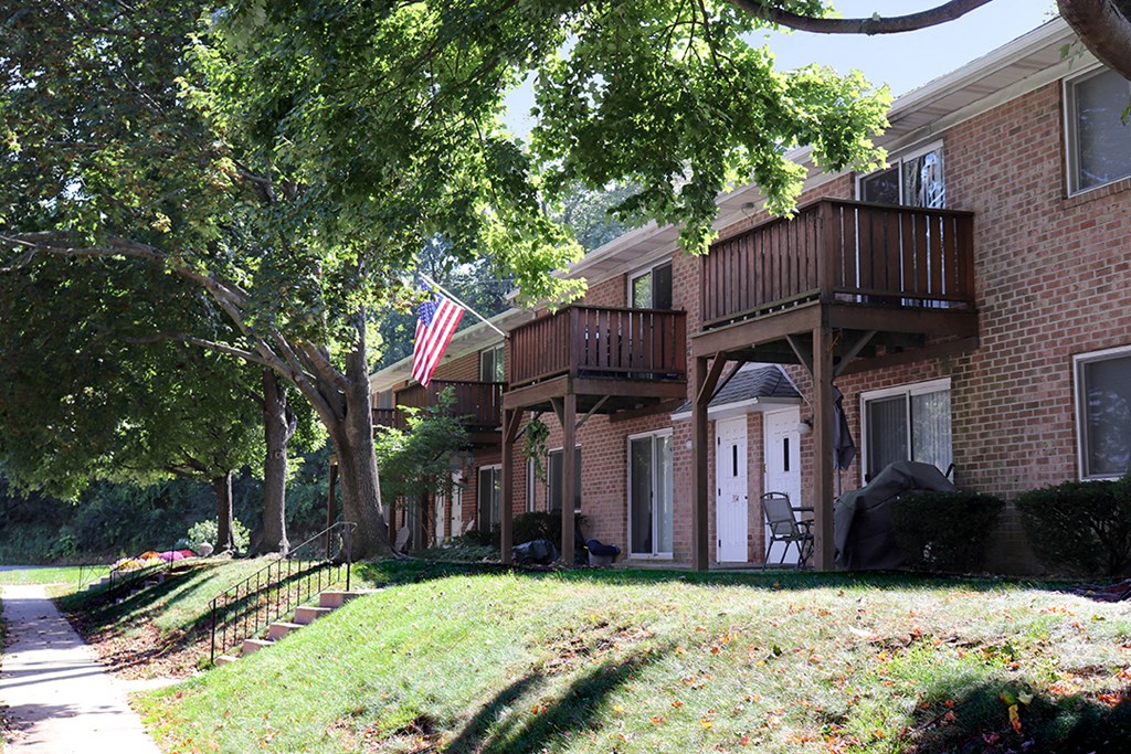 a brick building with a balcony and an flag