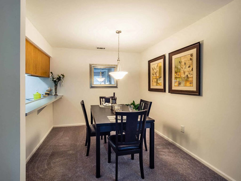 a dining room with a table and chairs