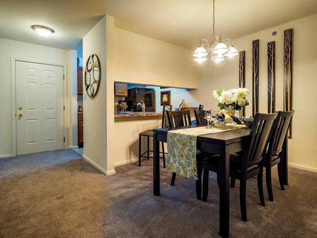 a dining room with a table and chairs