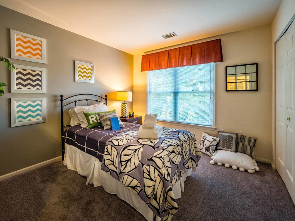 a bedroom with a bed and a window