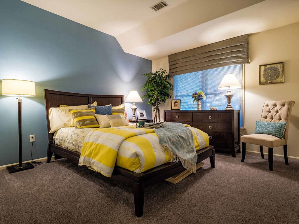 a bedroom with a bed and a dresser