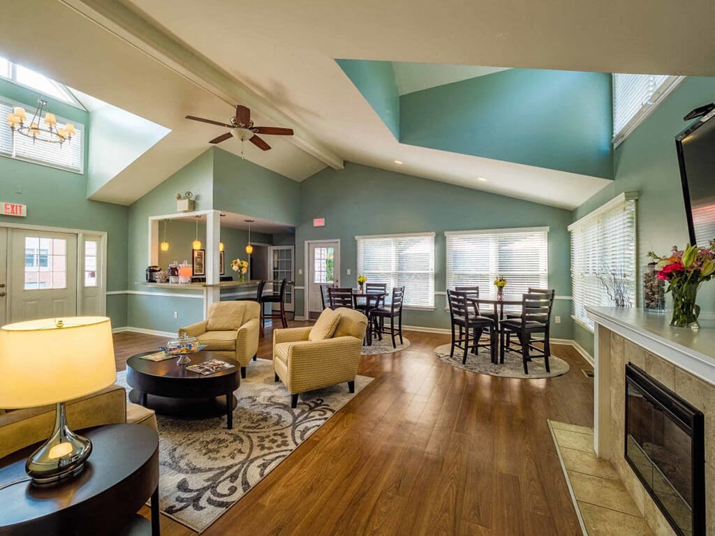 a living room with a fireplace and a dining room