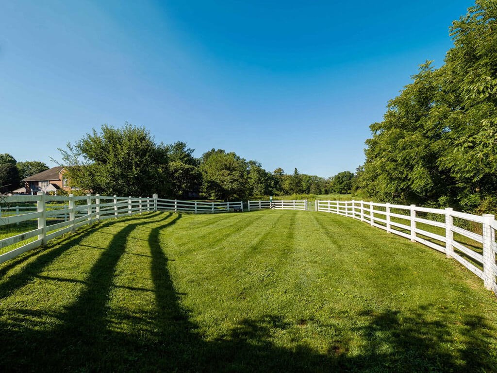 a fenced in pasture with a white fence