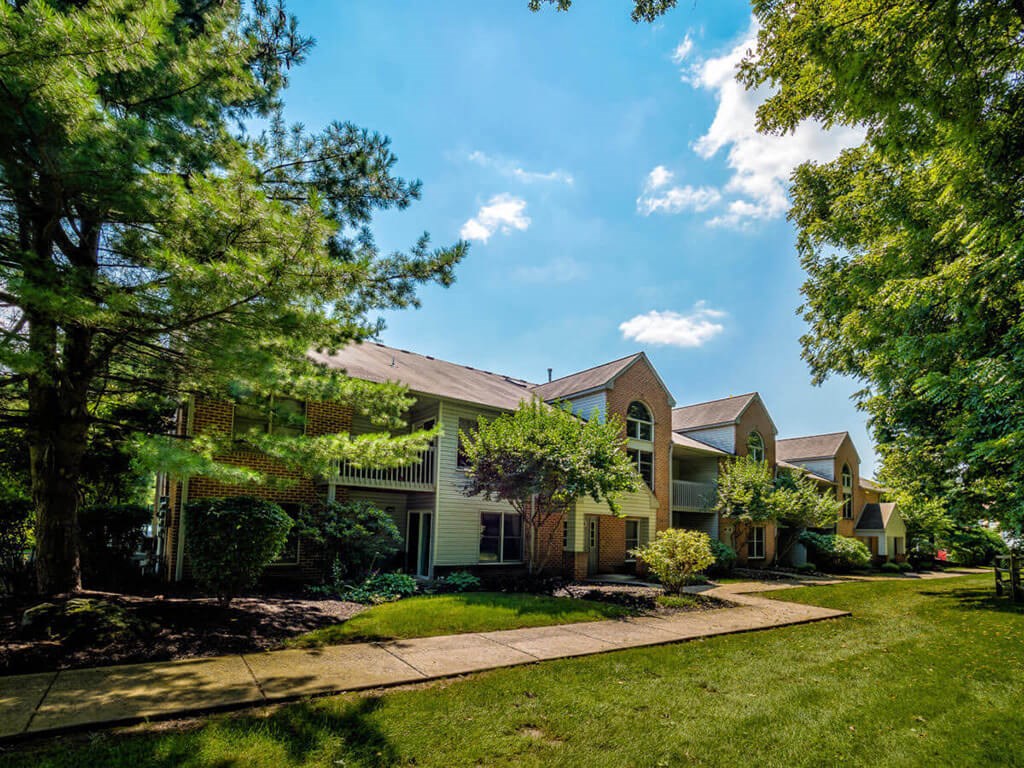 front view of the house with lawn and trees