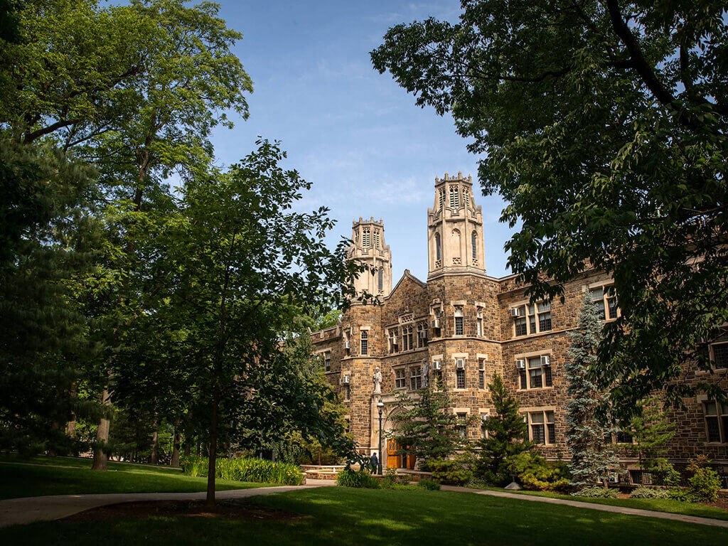 a large brick building with trees in front of it