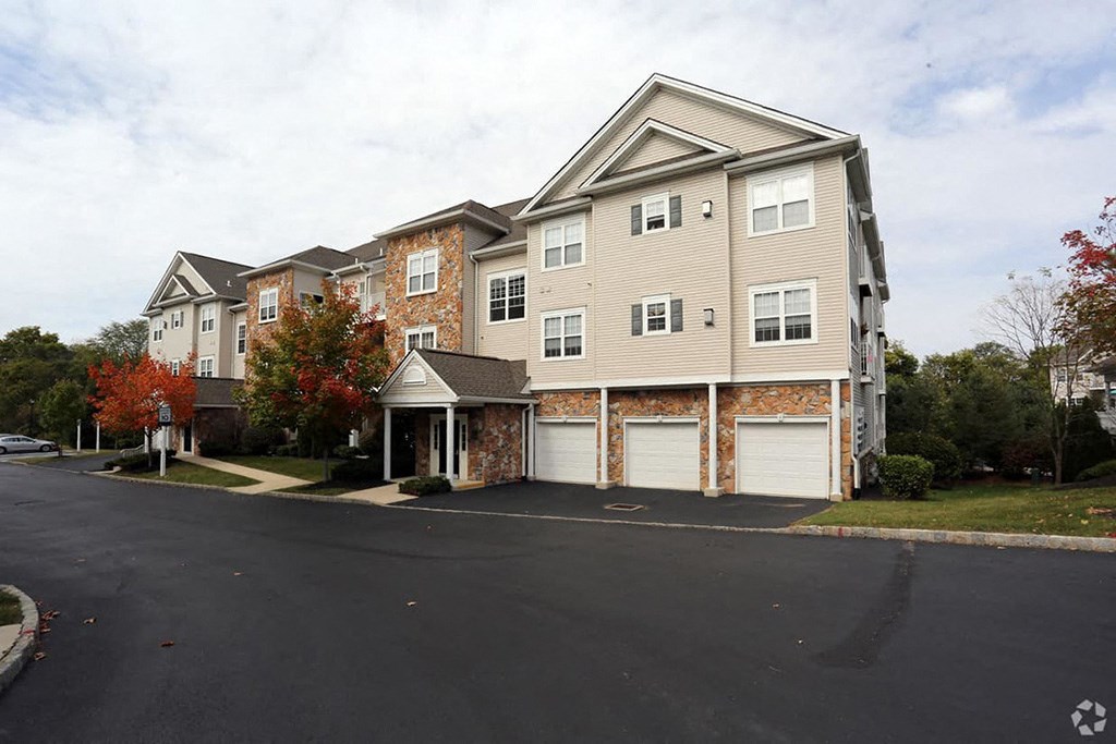 a building with two garages and a street in front of it