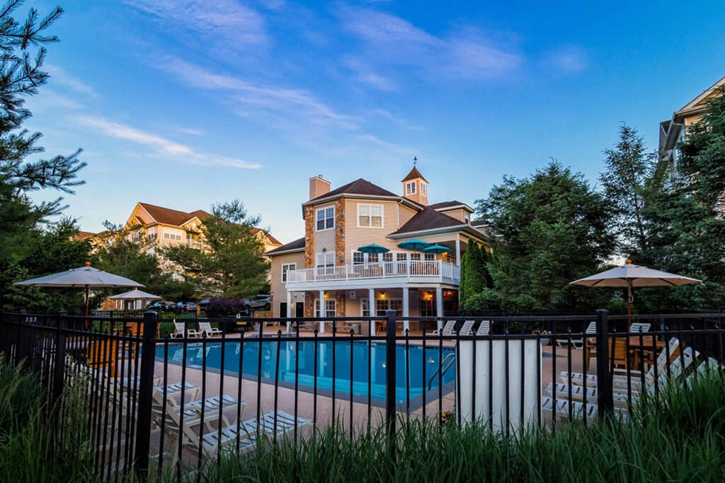 a swimming pool in front of a house