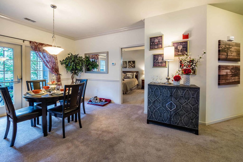 a dining room and living room with a table and chairs