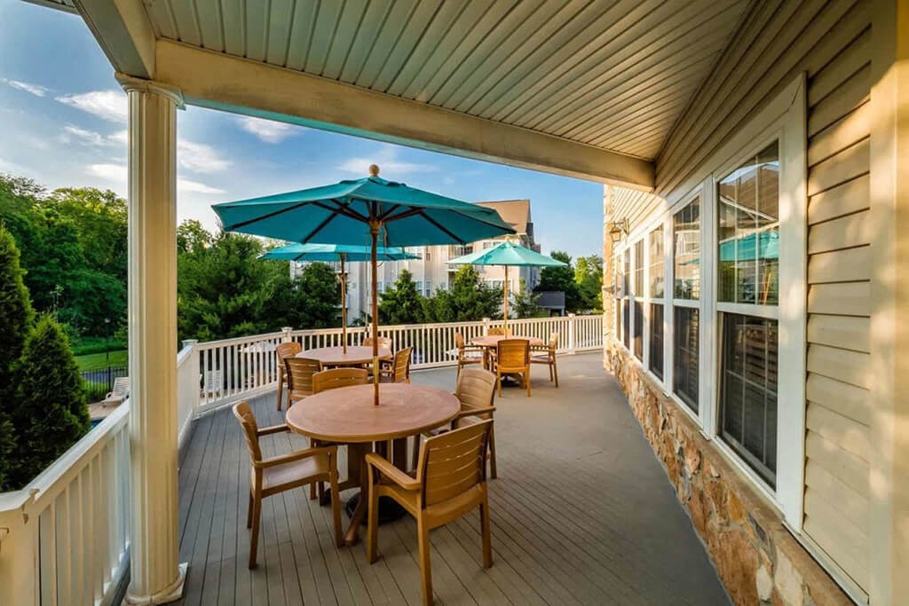a covered patio with tables and chairs and umbrellas