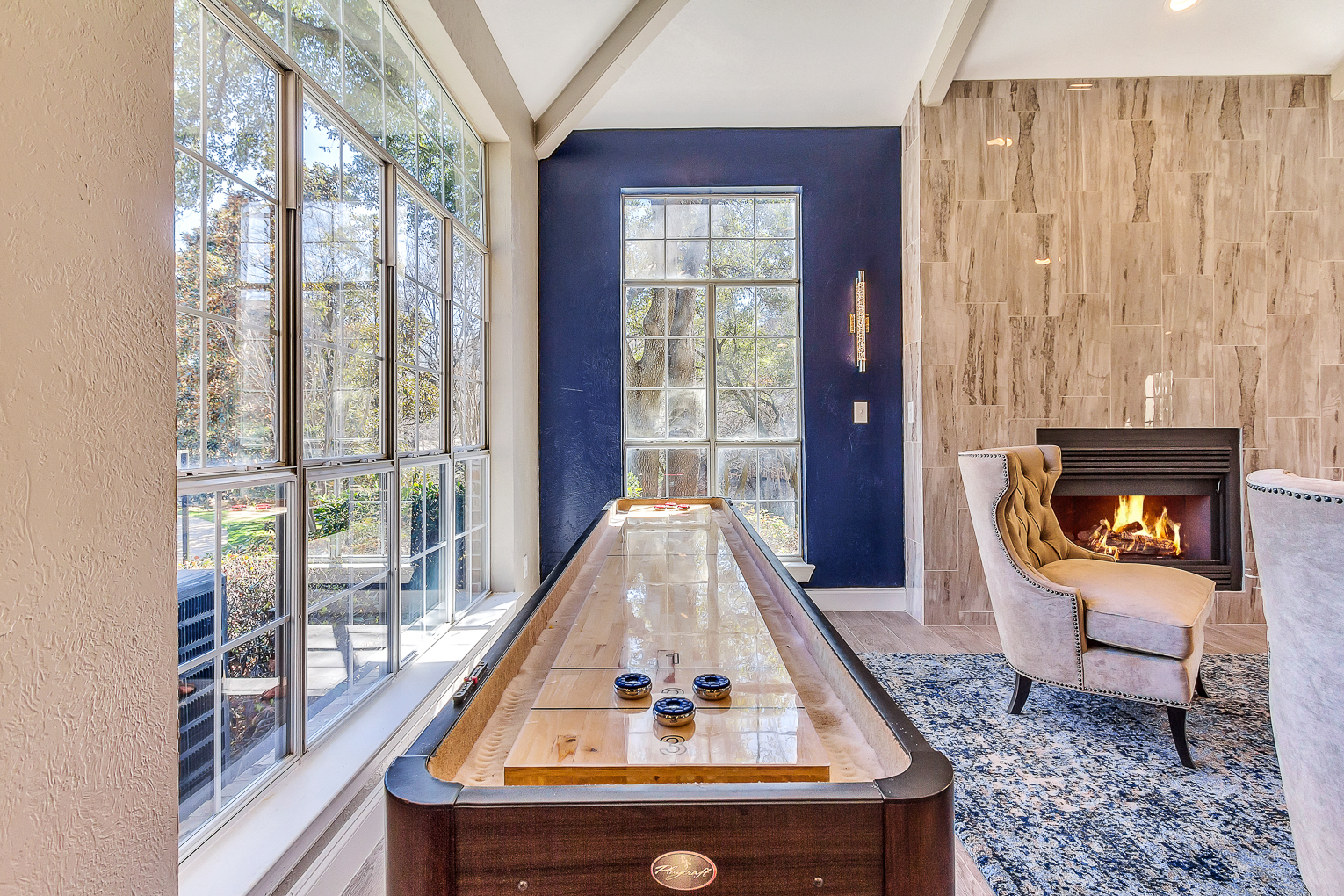 Resident lounge with games, lounge seating and fireplace