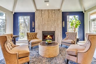 Resident lounge with plush seating, natural lighting and fireplace