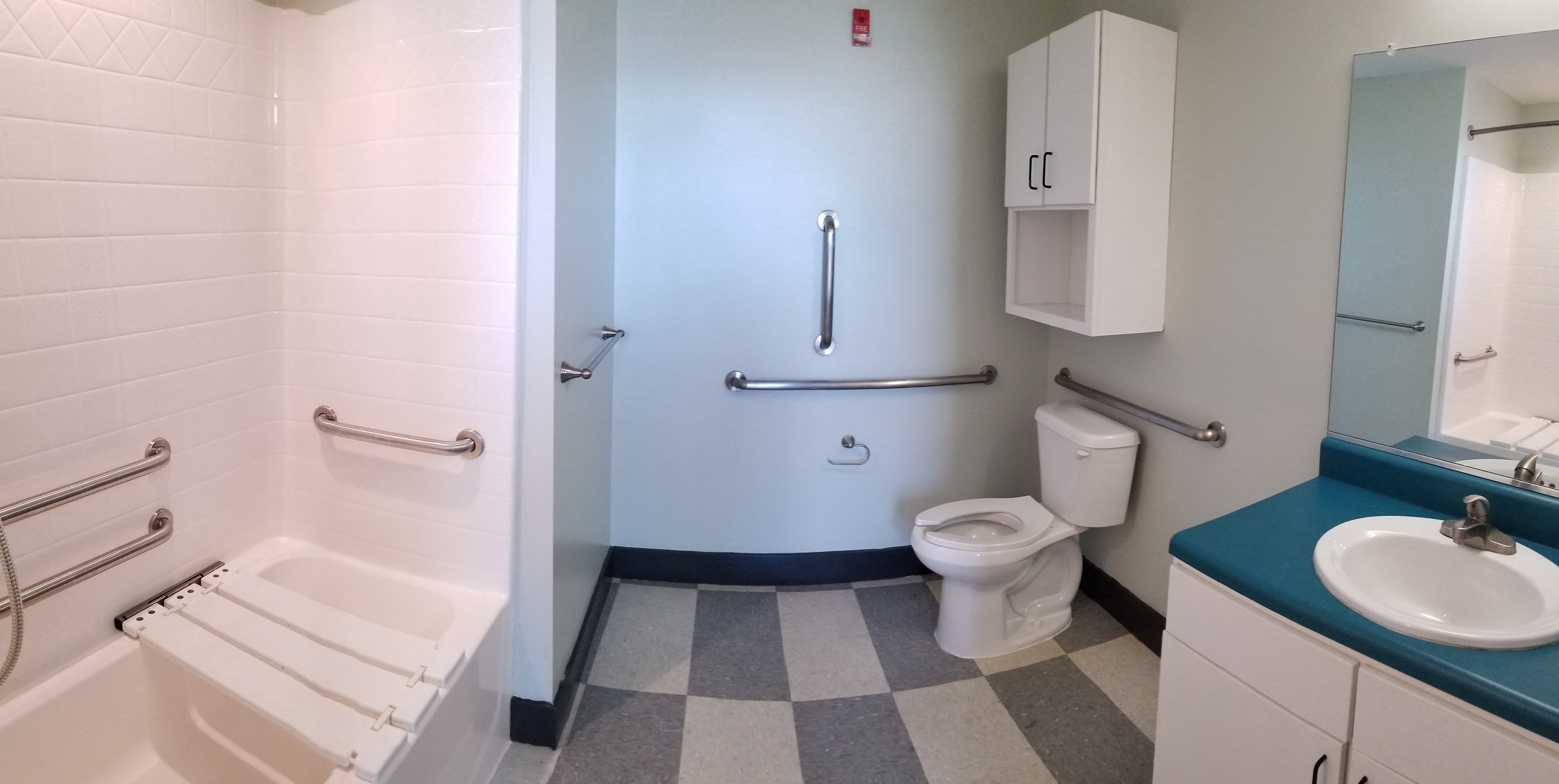 a bathroom with a toilet and a sink and a tub