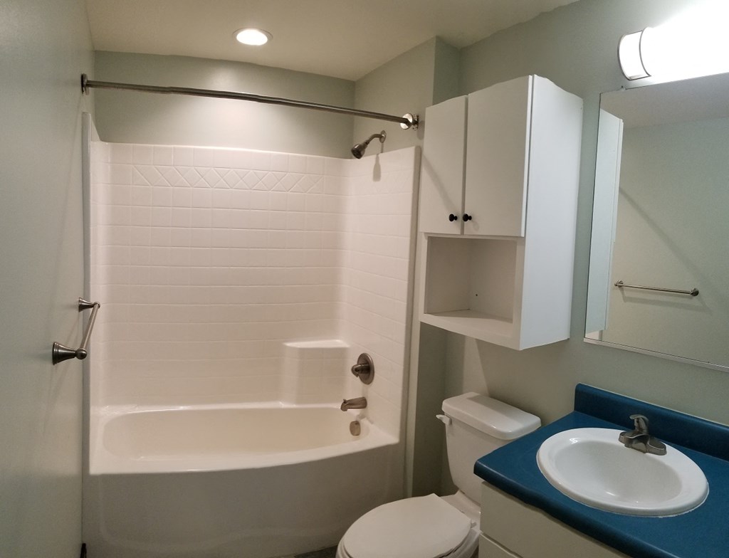 a small bathroom with a sink toilet and shower