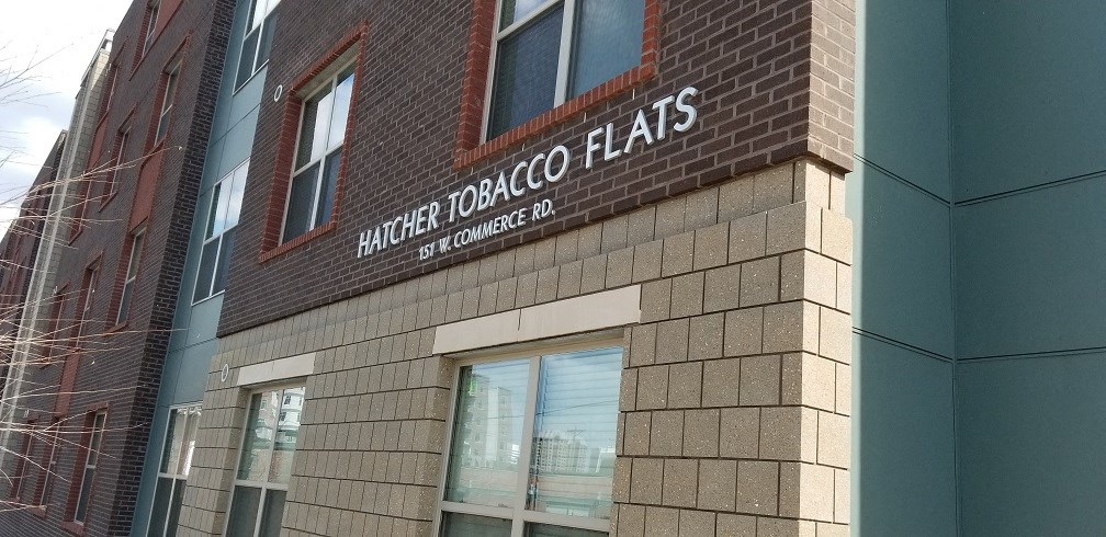 a brick building with a sign that reads angel flats