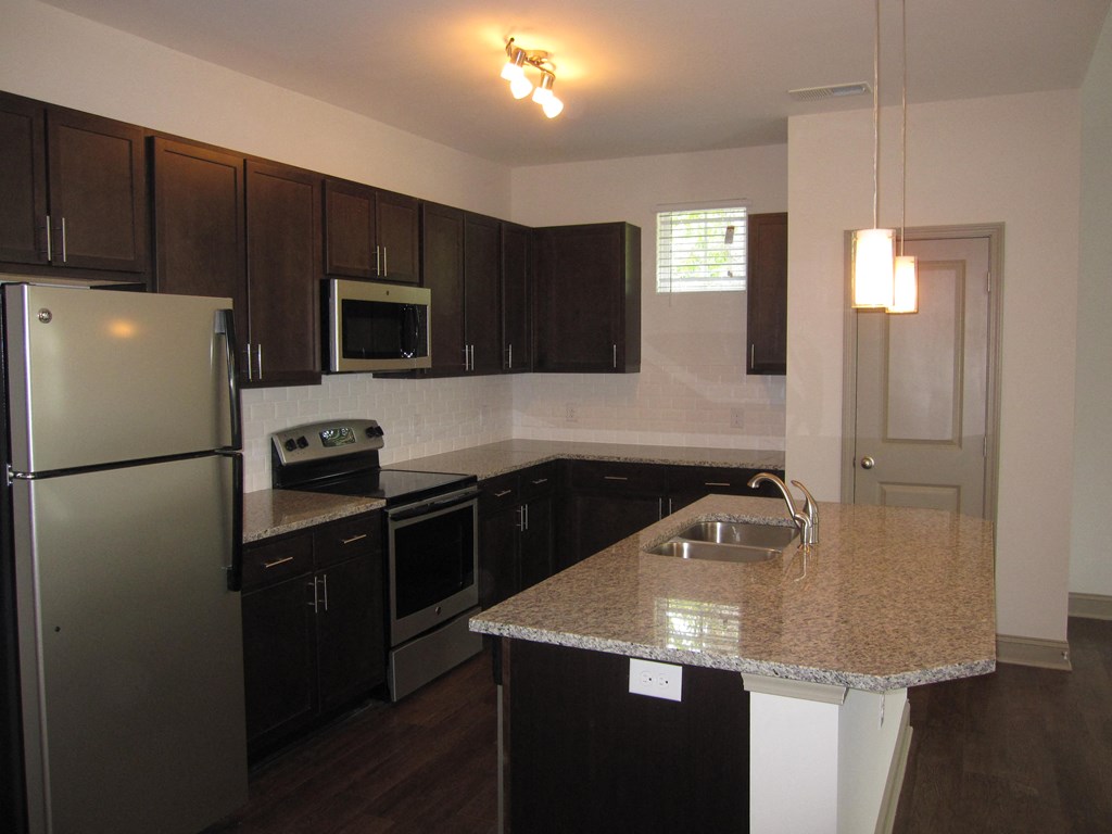 a kitchen with stainless steel appliances and a granite counter top