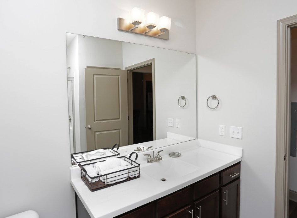 a bathroom with a sink and a large mirror