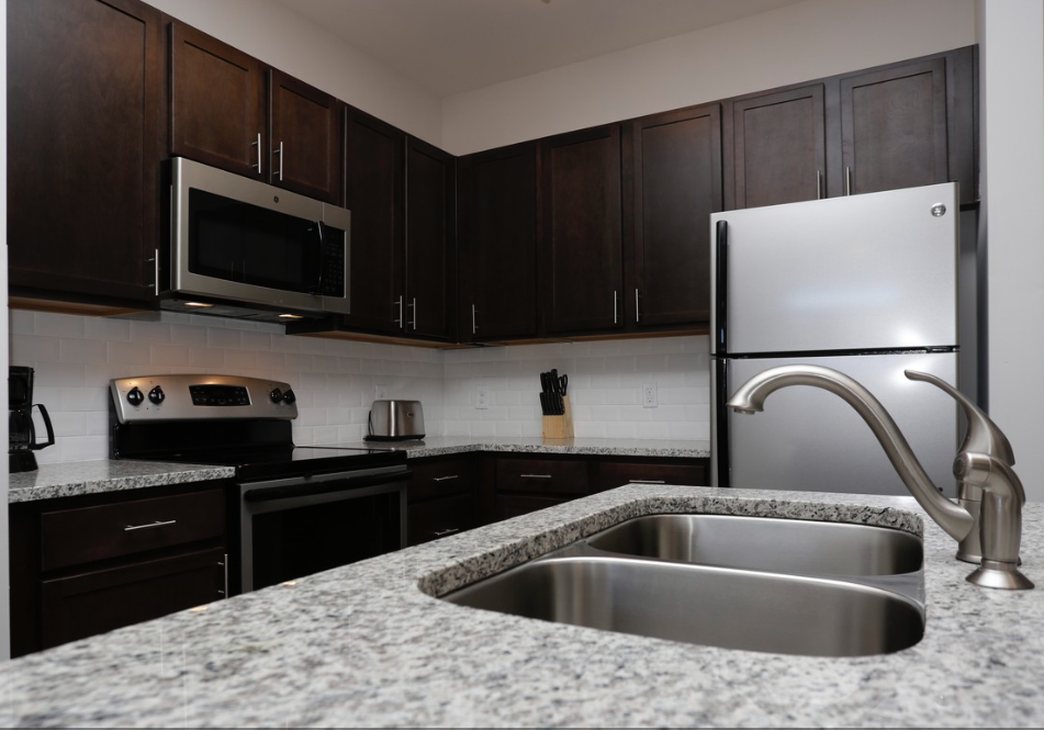 a kitchen with granite counter tops and black and white appliances