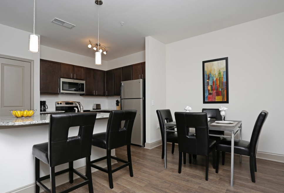 a dining room and kitchen with a table and chairs