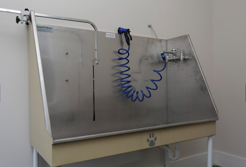 a stainless steel table with a dialysis machine with a blue hose on it