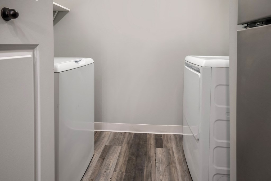 a laundry room with two washers and a dryer in it