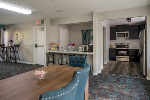 a living room with a dining room table and a kitchen