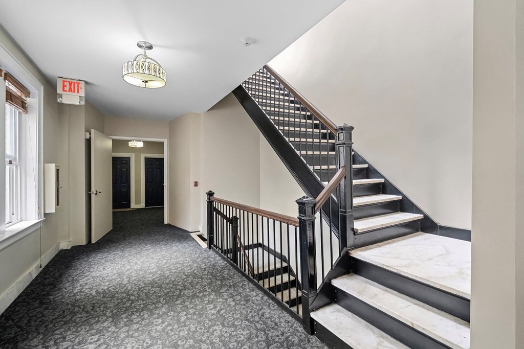 a stairwell in a building with a staircase and a door