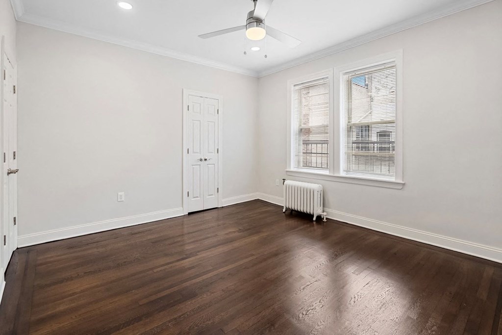 an empty living room with wood floors and a white door