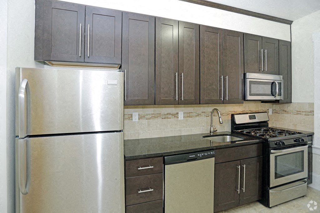 a kitchen with stainless steel appliances and wooden cabinets