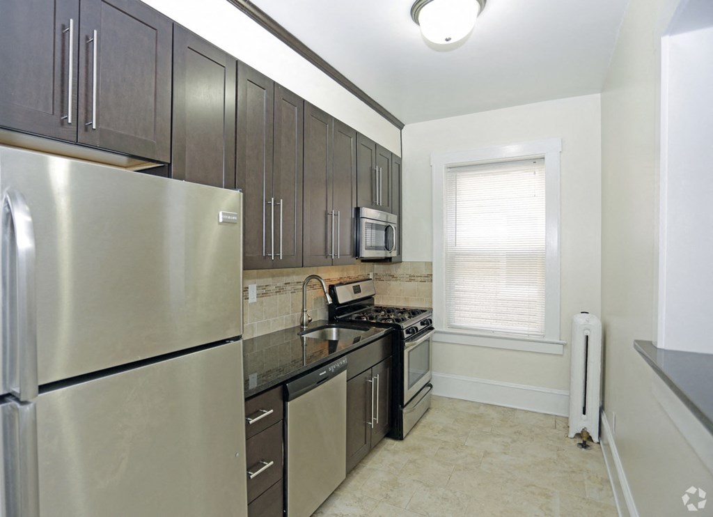 a kitchen with stainless steel appliances and wooden cabinets