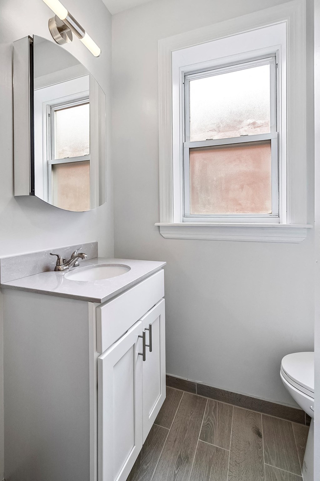 a small bathroom with a sink and a window