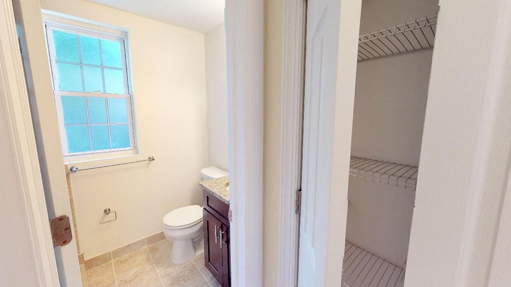a bathroom with a toilet and a window