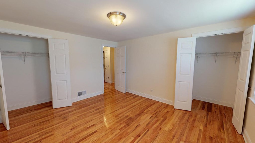 a living room with a wood floor and a closet