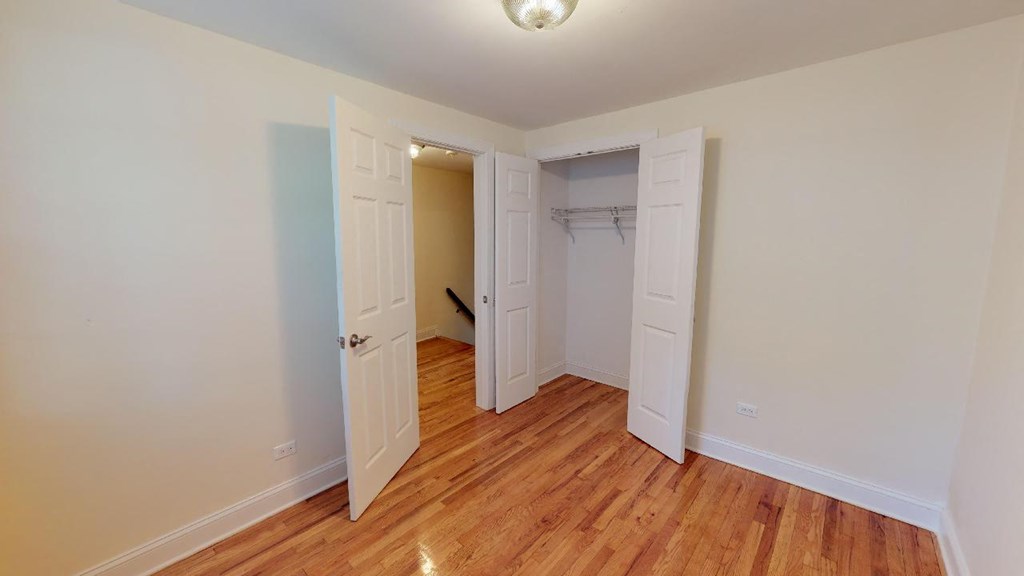 a bedroom with two closets and a door to a closet