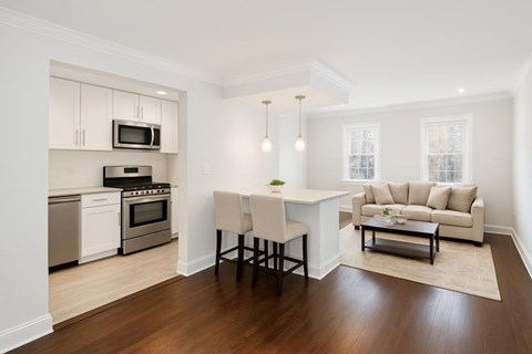 A modern kitchen with a dining table and chairs.