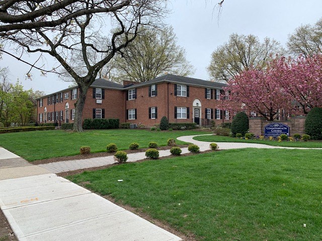 a sidewalk in front of a brick building