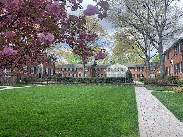 a green lawn in front of a brick building