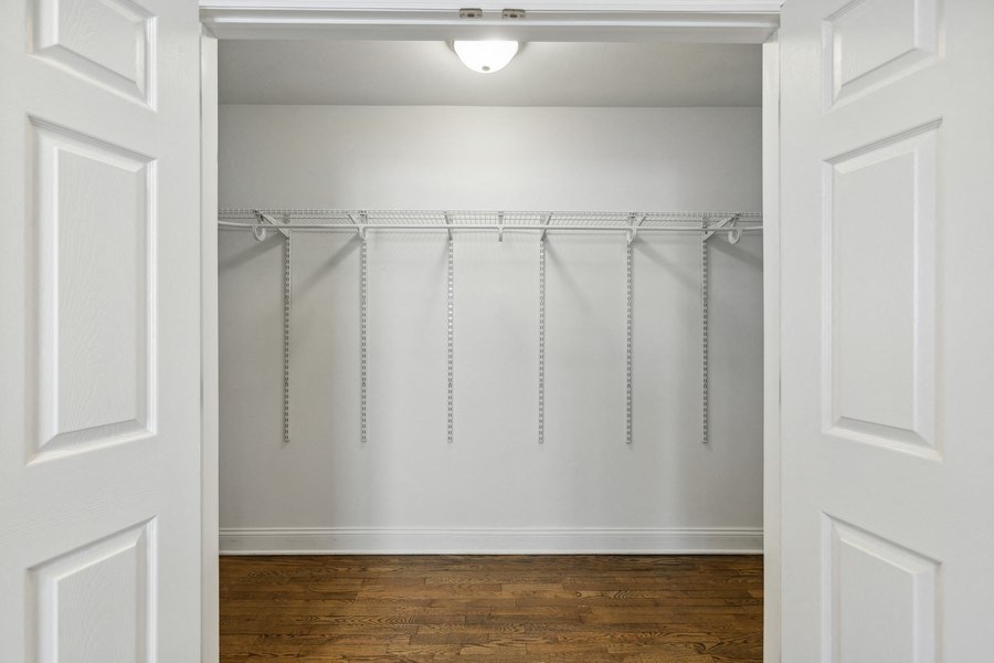 an empty room with white walls and a wood floor