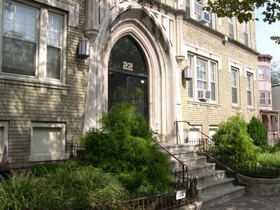 a brick building with a large door and stairs