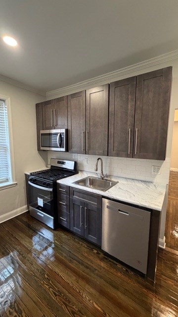A kitchen with dark wood cabinets and a white countertop.